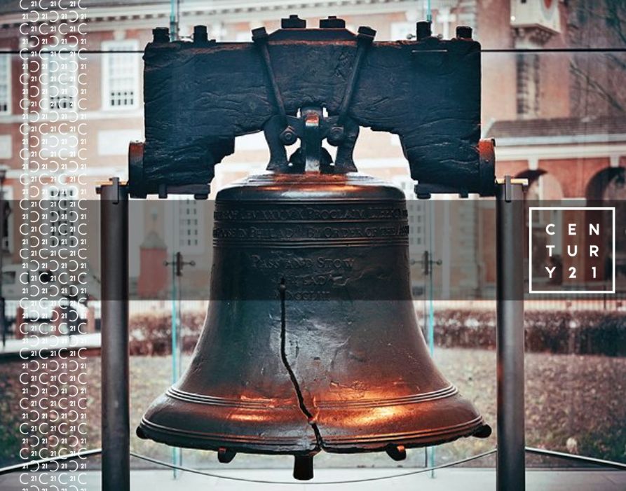 Liberty Bell in a museum setting with the Independence Hall in the background and CENTURY 21 branding